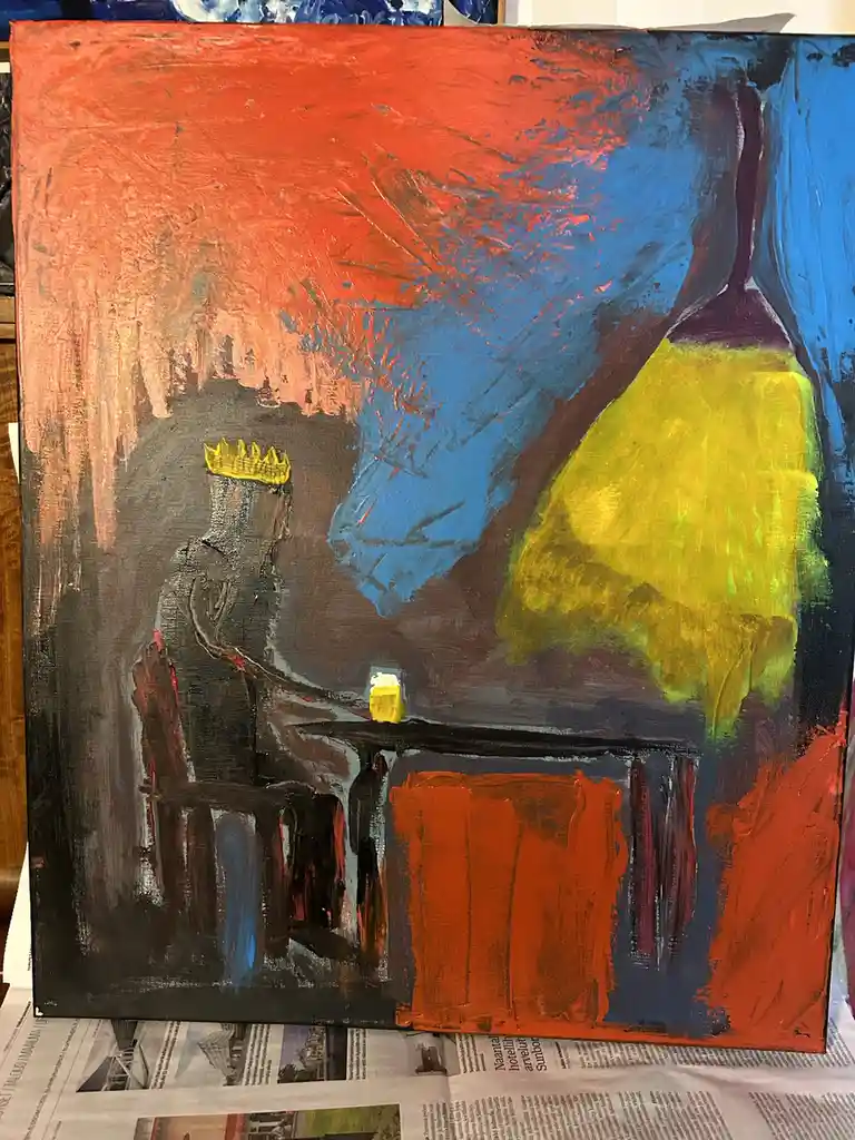An abstract painting depicts a dark, silhouetted figure wearing a yellow crown, seated at a table with a small yellow…